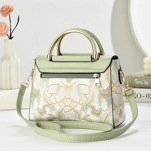Elegant mint green handbag with floral embroidery and gold metal handles for women