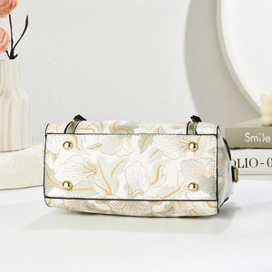 Structured bottom of contrast color floral handbag with gold protective metal feet