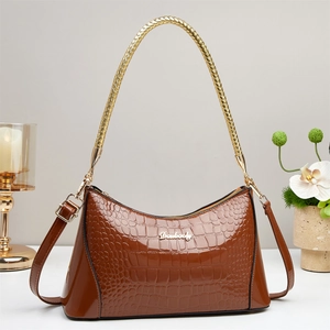 Glossy brown crocodile pattern leather handbag with adjustable straps and gold hardware