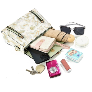 Floral contrast color handbag with crossbody strap showing spacious interior capacity