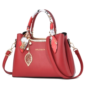 Elegant red bridal tote bag in pebble leather with silk scarf and leaf pendant charm