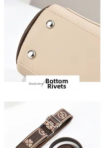 Detail of protective metal rivets on bag bottom and adjustable floral jacquard strap