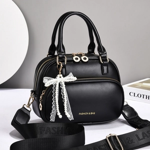 Chic black PU leather handbag with gold zipper and elegant pearl lace bow charm detail