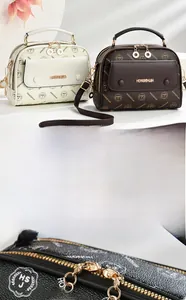 Detail of smooth two-way zippers and gold-plated hardware on high-quality tote bag