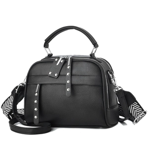 Minimalist black lychee leather handbag with silver rivets and striped wide strap