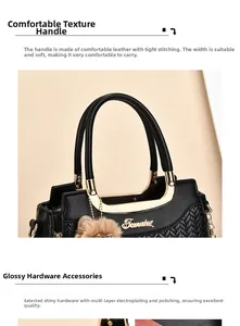 Detailed view of woven black handbag featuring golden brand logo and premium metal hardware