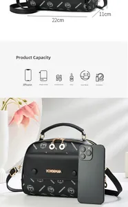 Detail view of black leather handbag with logo pattern showing 22cm size and interior capacity