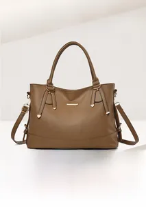 Detailed view of brown lychee grain top layer leather handbag with gold hardware