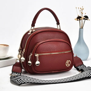 Elegant wine red round multi-layer crossbody bag with textured leather and wide strap