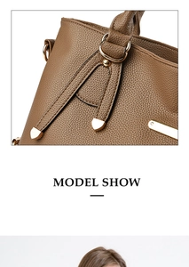 Close-up of brown litchi pattern leather texture with elegant gold hardware buckles