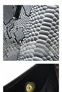Detailed view of grey snakeskin texture fabric and golden magnetic snap fastener