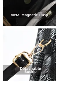Detail of snake print leather bag with gold magnetic snap closure and detachable hook