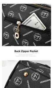 Close-up of the back zipper pocket and golden hardware on this vintage black tote bag