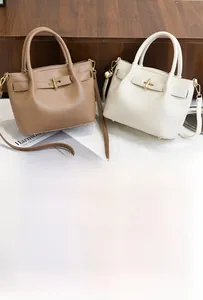 Close-up of litchi pattern PU leather bucket bags with gold locks in khaki and beige
