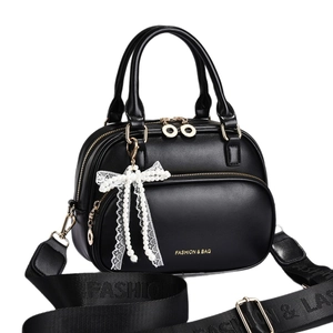 Black PU leather handbag for women with a white lace bow and wide crossbody strap