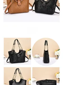 Detail view of snakeskin embossed tote bags in black and brown with gold chain straps