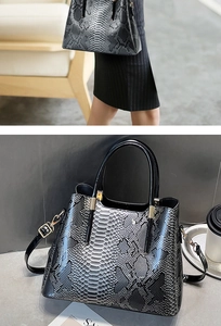 Detail of faux snake skin texture and detachable strap on black gradient backpack