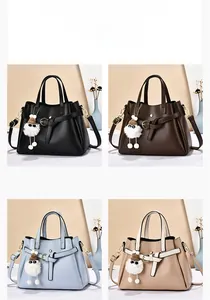Close-up of litchi texture crossbody bags in black, coffee, blue, and khaki colors