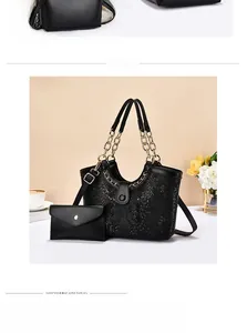 Detail of black crocodile texture tote bag set with chain handle and envelope clutch