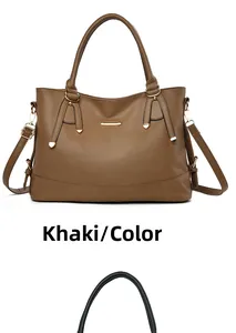 Detail of khaki pebbled leather tote bag with gold metal trim and detachable strap
