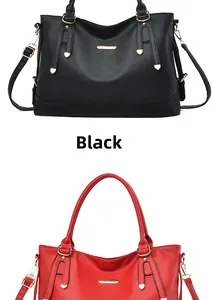 Close-up of litchi texture leather tote bag in black and red with gold metal details