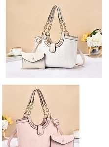 Detail of elegant tote bag with matching envelope pouch and golden chain handles