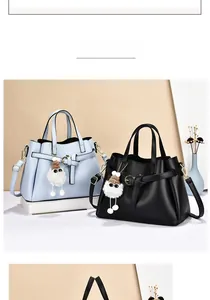 Litchi pattern leather handbags with bow pendant in light blue and black versions