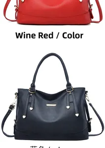 Detailed view of wine red and navy blue soft leather handbags with litchi grain texture