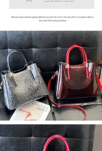 Detailed view of glossy snake-pattern embossed tote bags in grey and wine red colors