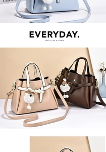 Detail of high-quality lychee grain leather crossbody bag with bow pendant and plush ball