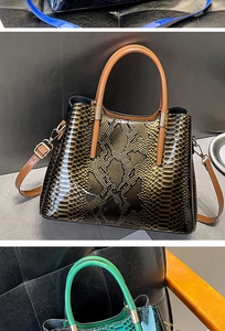Close-up of gradient snakeskin texture on shiny leather handbag with gold-tone hardware