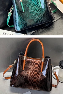 Detail of glossy snakeskin texture on retro tote bags with handles and straps