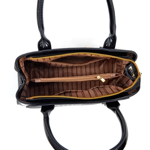 Internal view of black crocodile pattern handbag with striped lining and zipper compartments