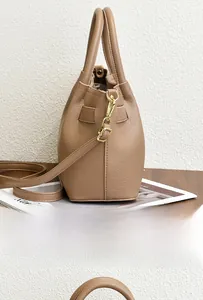Close-up of litchi texture PU leather bag with golden hardware and side strap detail