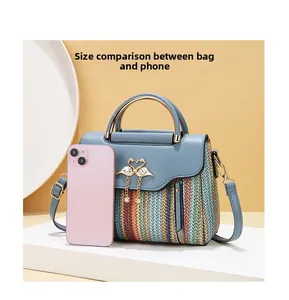 Size comparison between the woven crossbody bag and a mobile phone for scale