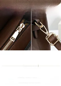 Close-up of brown lychee texture leather handbag with gold zipper and metal lobster clasp