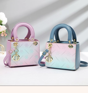 Detailed macro of gradient embossed handbag with floral texture and gold D-charm