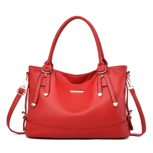 Large red pebbled leather tote bag with gold hardware and adjustable shoulder strap