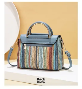 Detail view of the colorful woven handbag back side showing blue leather and hidden zipper