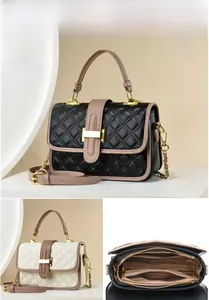 Detail view of the interior layered zipper structure and metallic clasp on the quilted bag