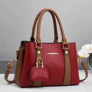 Elegant wine red and brown two-tone faux leather tote bag with gold metal accents