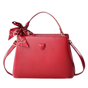 Red bridal bucket handbag with heart detail and silk scarf for wedding festivities