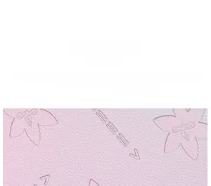 Macro detail of pink synthetic leather with fine floral embossing and grain texture
