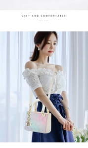 Detail of gradient pink to cyan PU leather handbag with star patterns and D-shaped charm