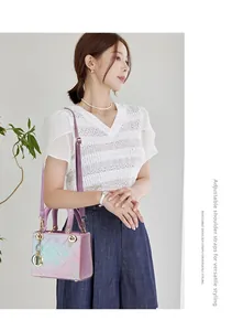 Detail of adjustable shoulder strap and gradient floral pattern on the handbag