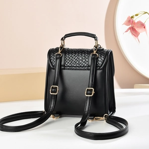 Minimalist black leather backpack with woven texture flap and gold hardware details