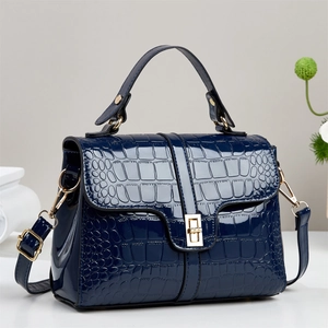 Dark blue patent leather handbag with crocodile pattern and golden metal buckle