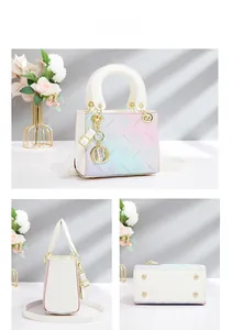 Detail view of pink-blue gradient bucket bag with cherry blossom embossing and metal charms