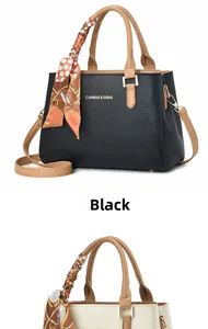 Dettaglio di eleganti borse in nero e bianco sporco con foulard in seta decorativo