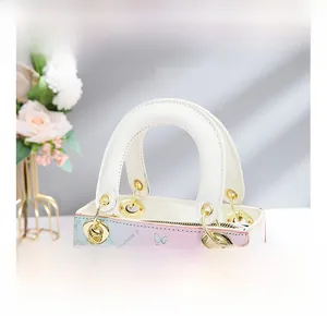 Detail of floral printed bucket bag showing wide handle and golden metal hardware